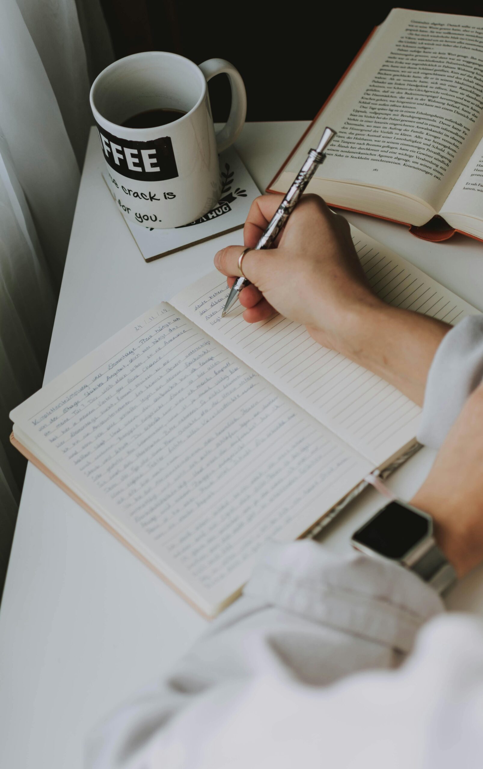 Person Writing on Notebook