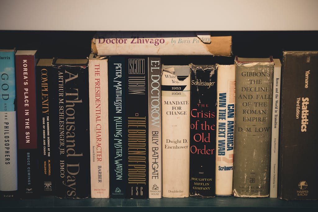 Close-up of classic literature on a wooden bookshelf, providing a vintage and educational feel.