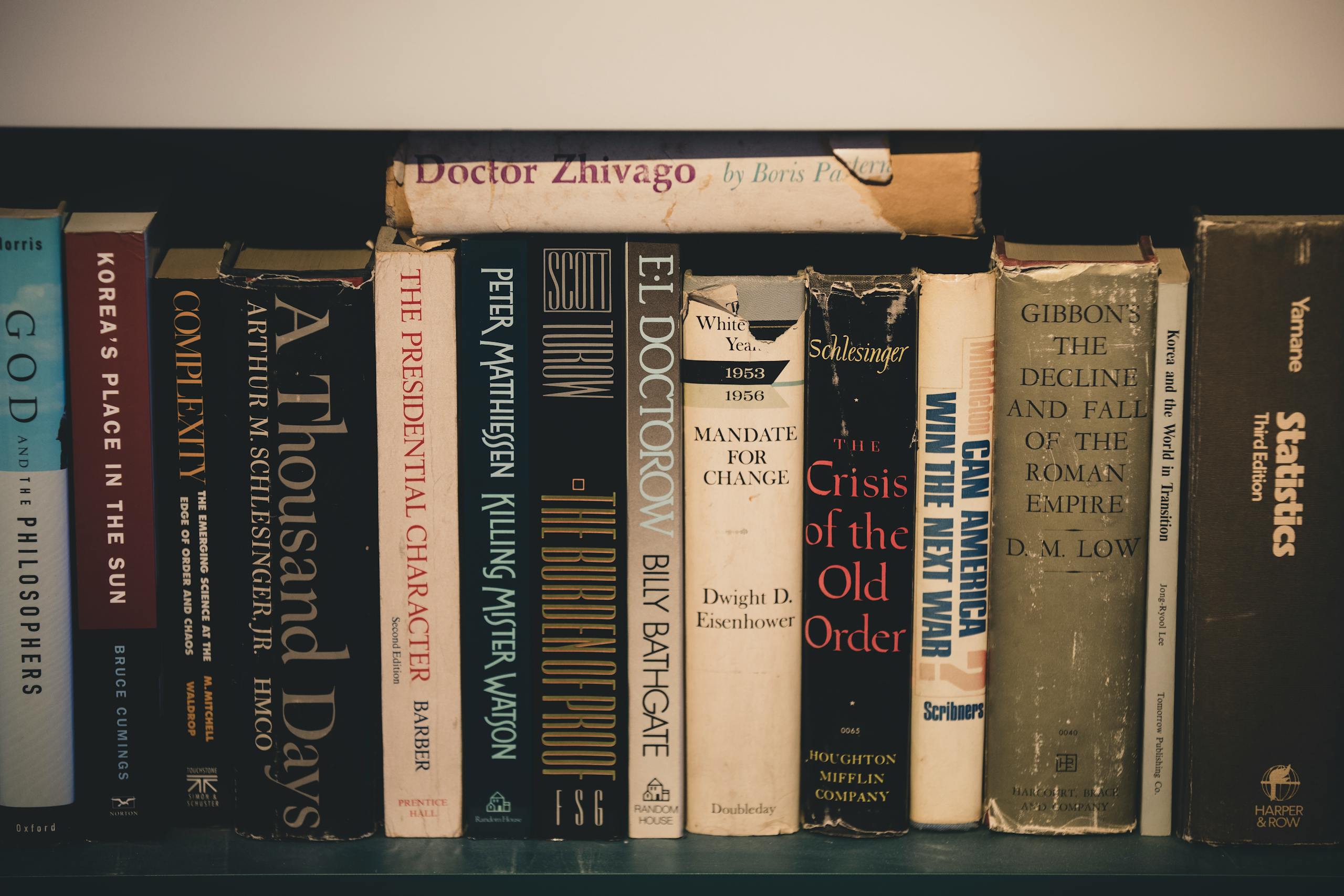 Close-up of classic literature on a wooden bookshelf, providing a vintage and educational feel.